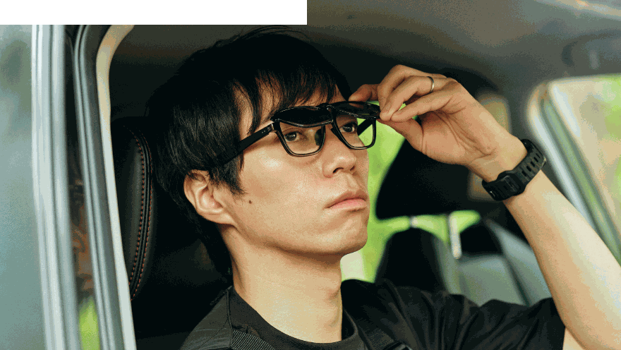 車内でメガネを掛け直す男性